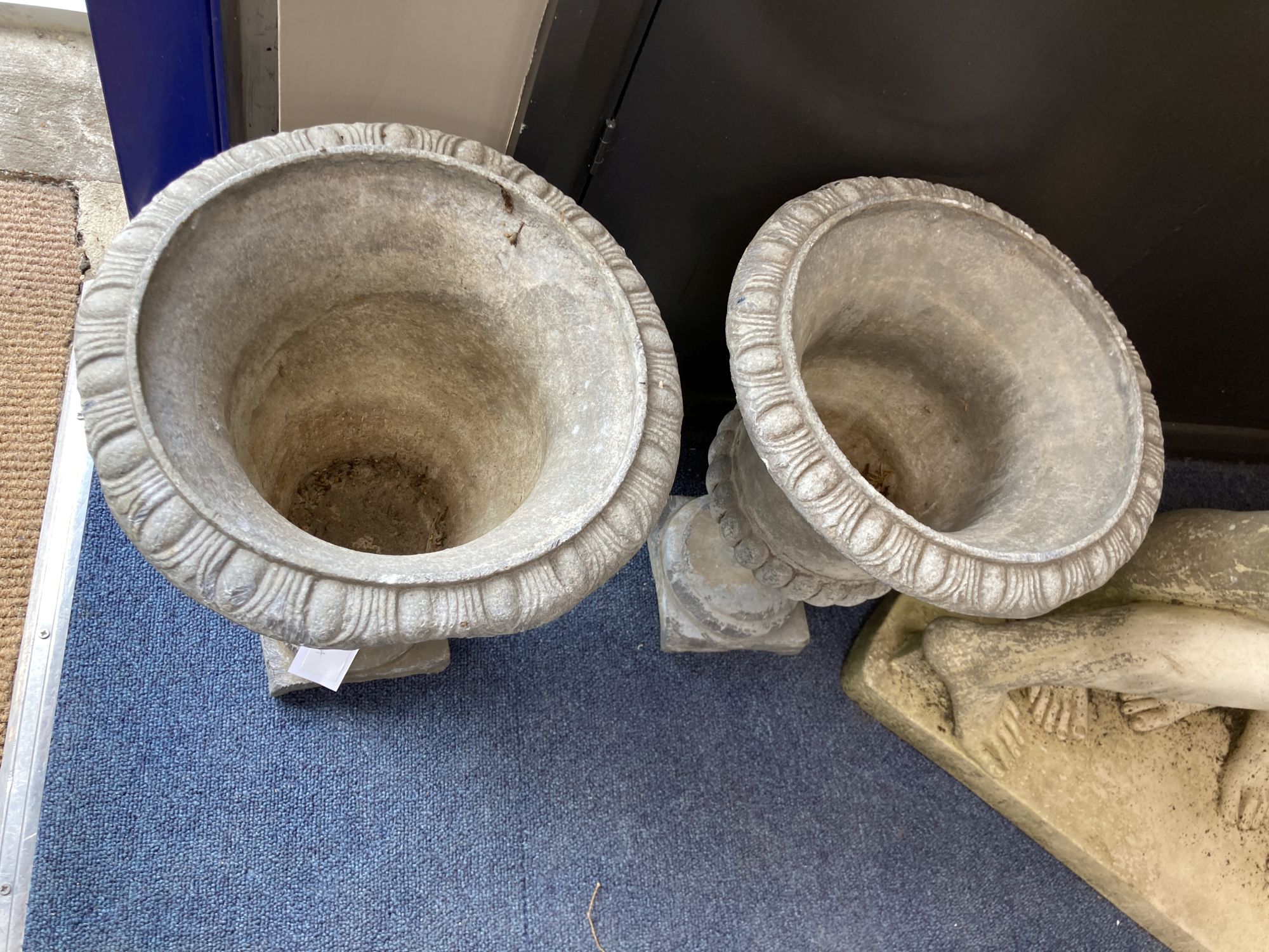 A pair of lead campana garden urns, 28cm diameter, height 36cm